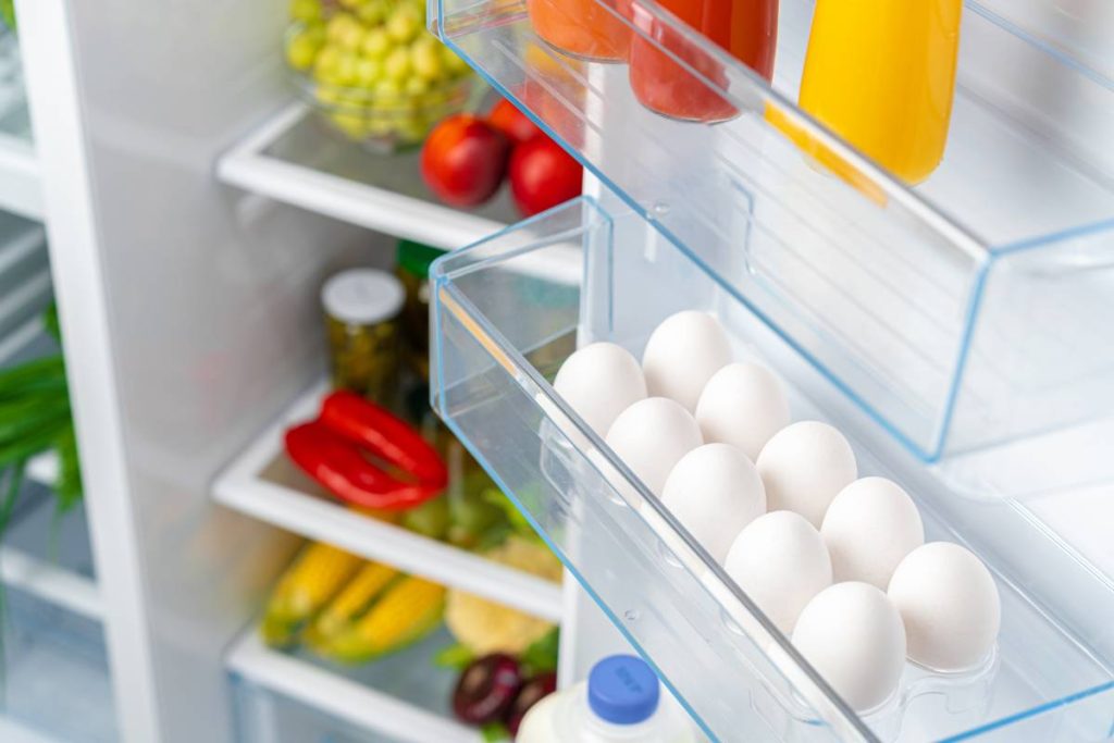 Pack of eggs on a fridge shelf close up
